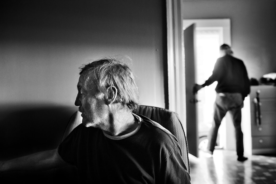 Paolo Pellegrin, Homeless men recently evicted from a tent city under the disused Rochester subway live temporarily in an apartment in the Crescent area of the city. Rochester, NY. USA 2012