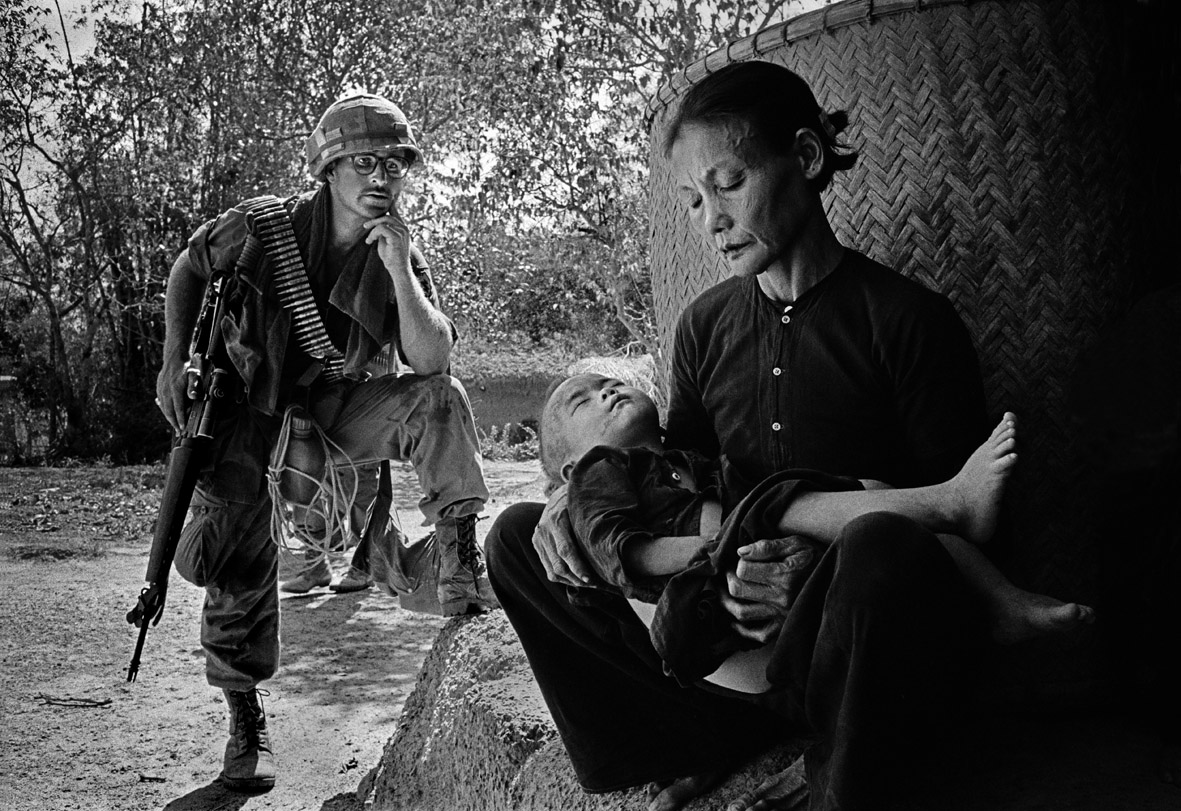 © Philip Jones Griffiths/Magnum Photos/Contrasto   VIETNAM. Quang Ngai. This was a village a few miles from My Lai.  It was a routine operation - troops were on a typical " search and destroy" mission. After finding and killing men in hiding, the women and children were rounded up.  All bunkers where people could take shelter were then destroyed.  Finally the troops withdrew and called in an artillery strike of the defenseless inhabitants. 1967