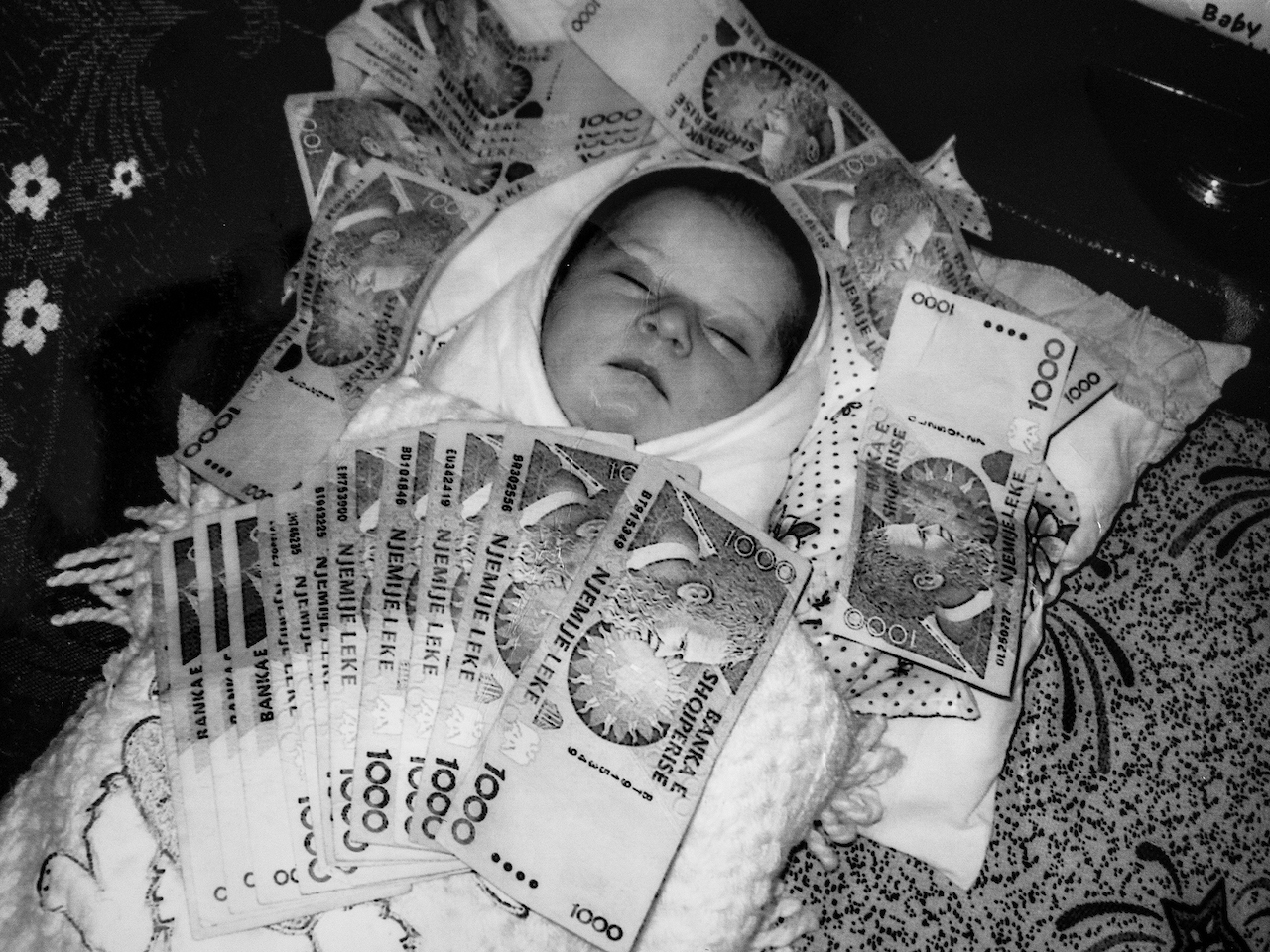 Just born baby boy. As a tradition relatives give as gifts to the infant and the new parents money. Bulqiza /Albania 2014