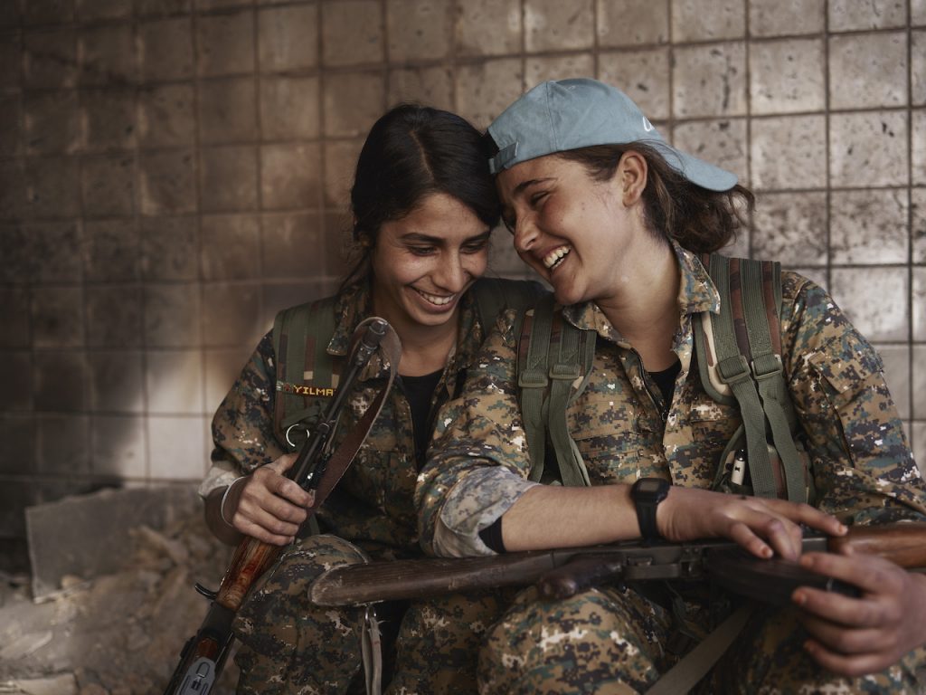 Joey Silava and Berivan share a laugh in an abandoned ISIS base