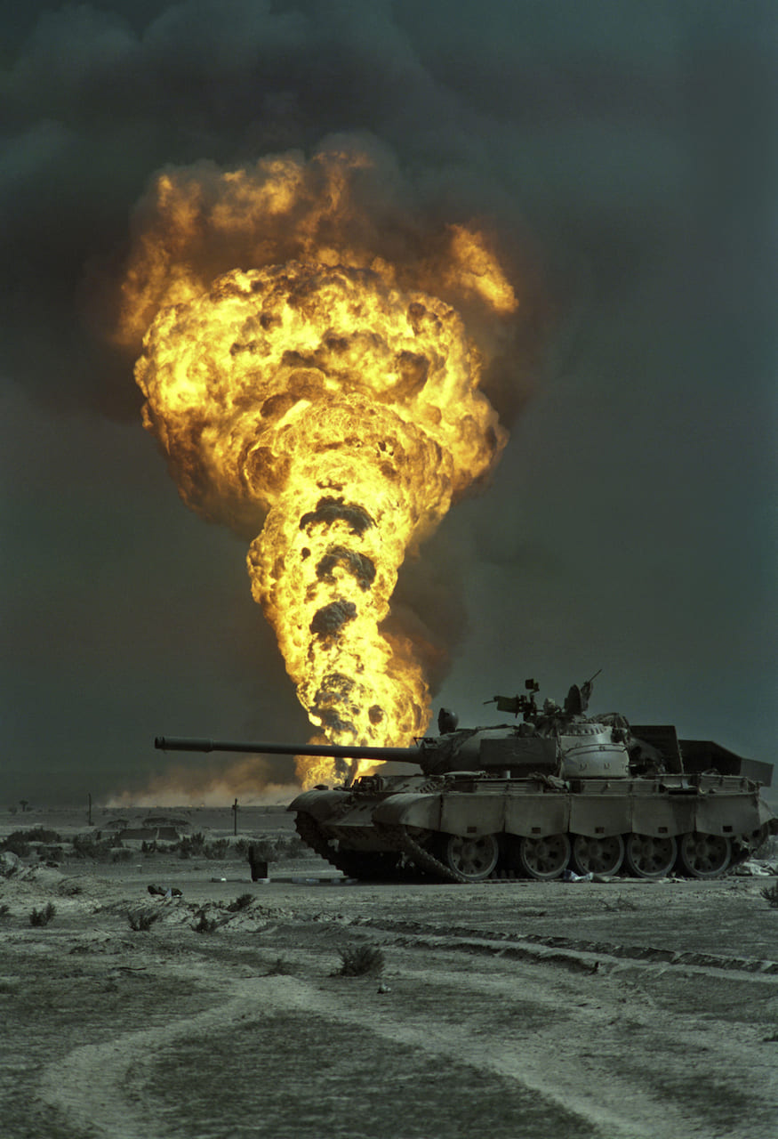 Livio Senigalliesi, 7th March 1991 An oil-well burns out of control beyond an abandoned Iraqi T55 tank in the Burgan oilfield, south of Kuwait City