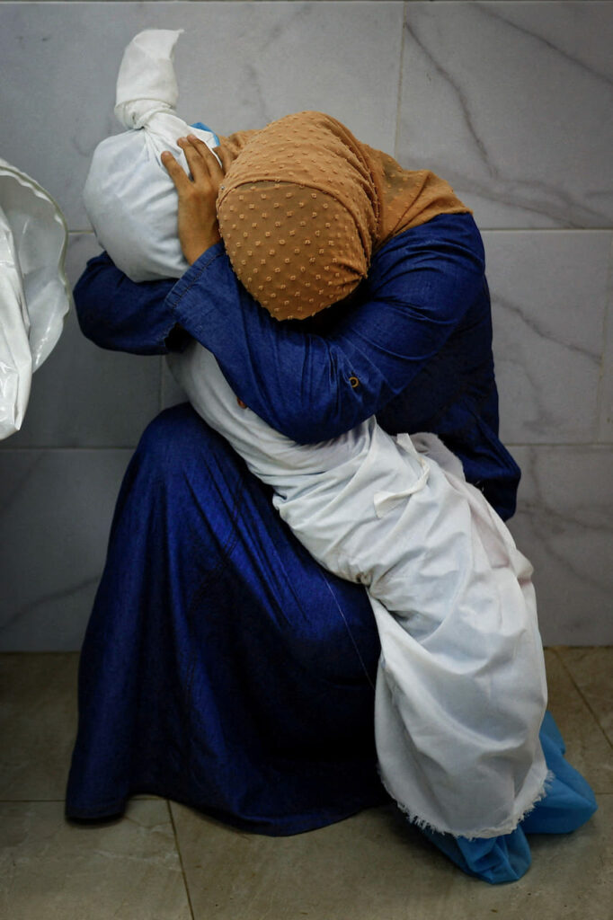 A Palestinian Woman Embraces the Body of Her Niece
© Mohammed Salem, Palestine, Reuters. Inas Abu Maamar (36) cradles the body of her niece Saly (5) who was killed, along with four other family members, when an Israeli missile struck their home. Khan Younis, Gaza, 17 October 2023.